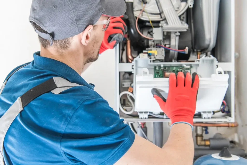 Technician repairing a heater furnace